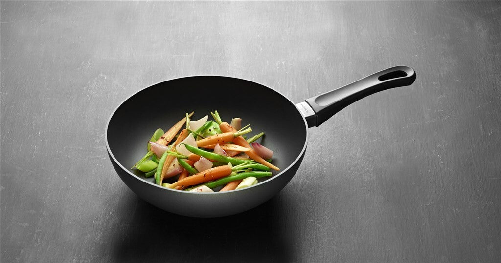 SCANPAN Classic Induction stir-fry pan with vegetables against a grey background