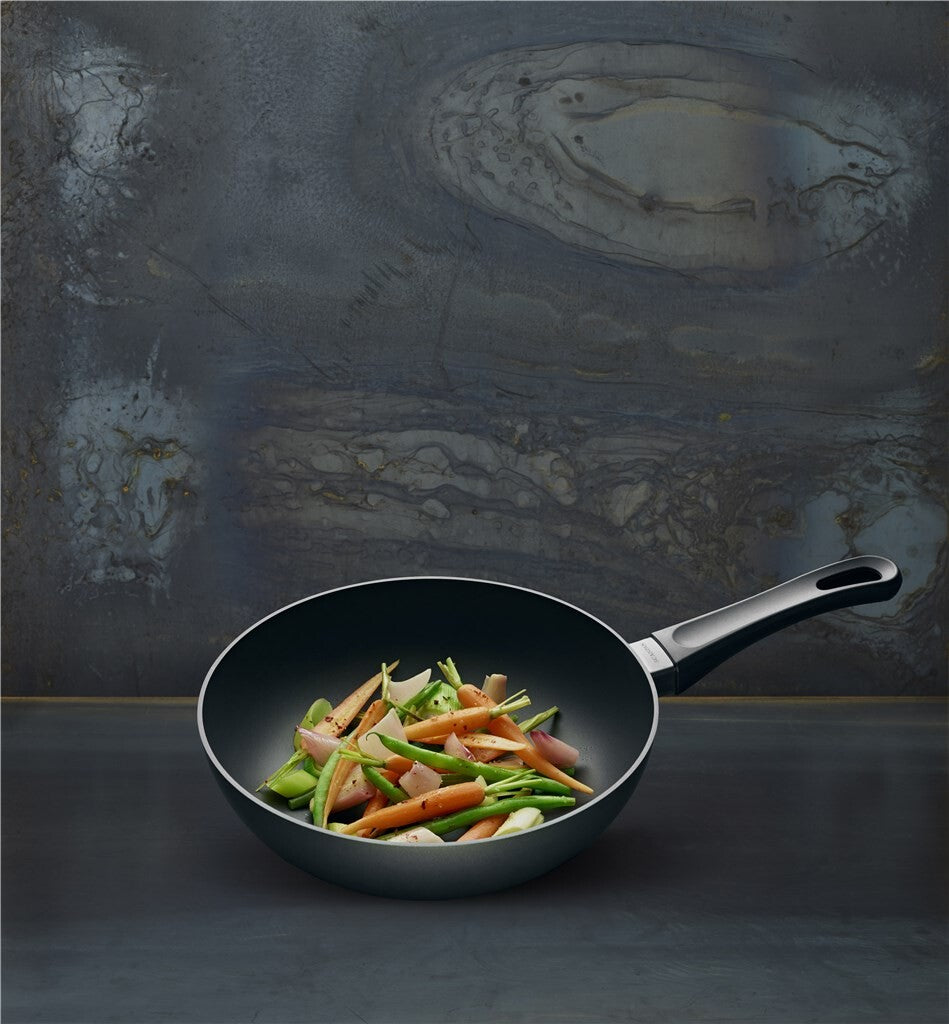 SCANPAN Classic Induction stir-fry pan with vegetables against a dark background