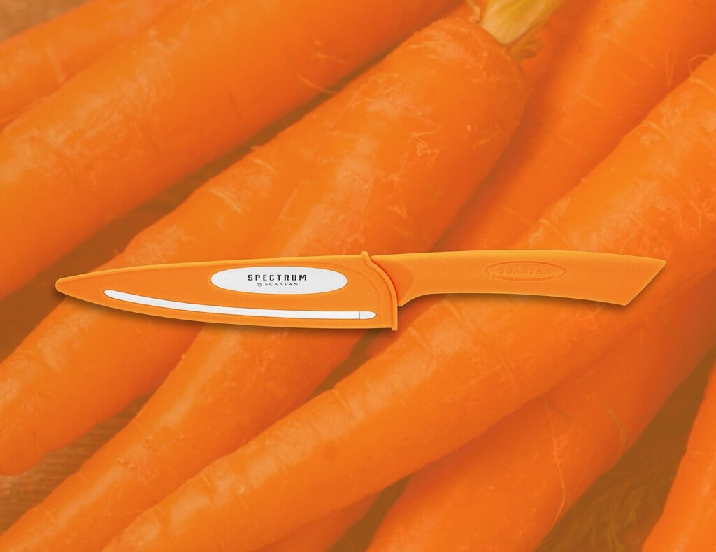 Spectrum utility knife in Carrot Curl shown in use