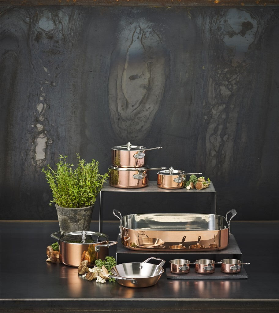 SCANPAN Maitre D' copper cookware collection with roasting pan on a dark kitchen counter
